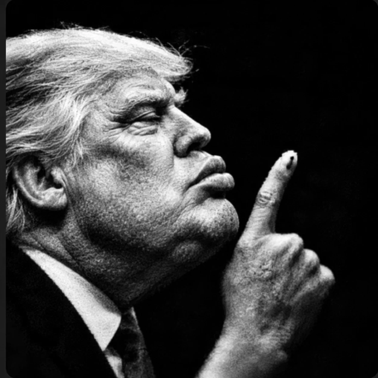 Mr. President in profile, finger to his lips